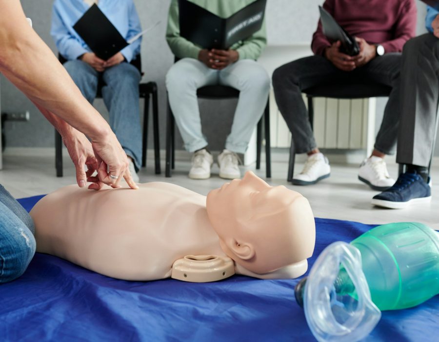 Instructor teaching first aid cardiopulmonary resuscitation course